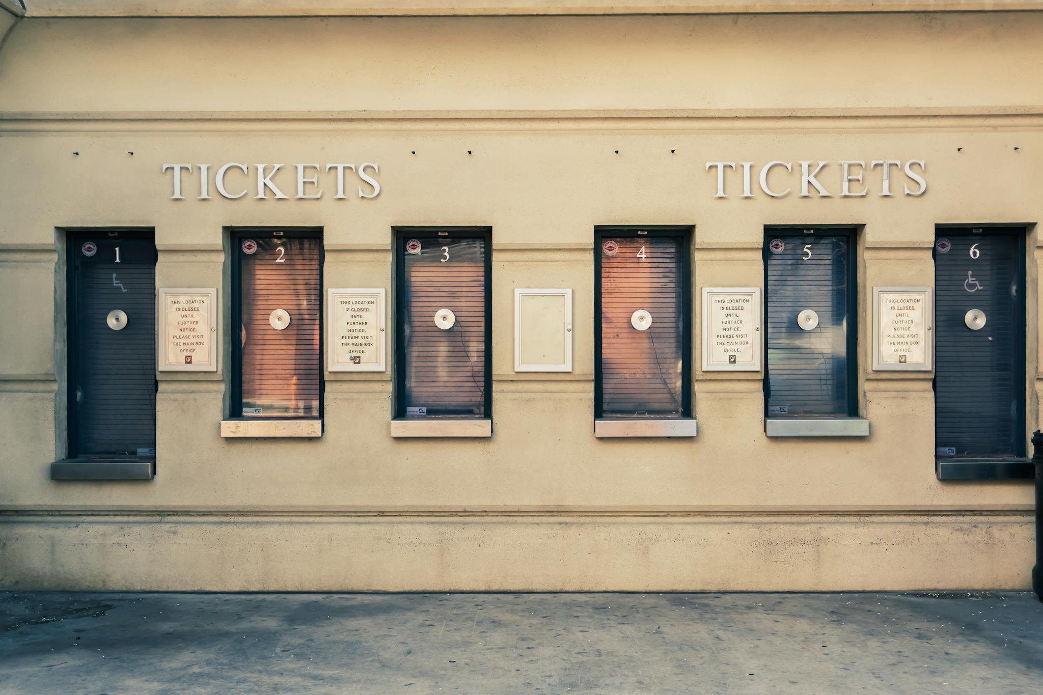 Row of closed ticket booths in Baltimore city center, showcasing urban architecture.