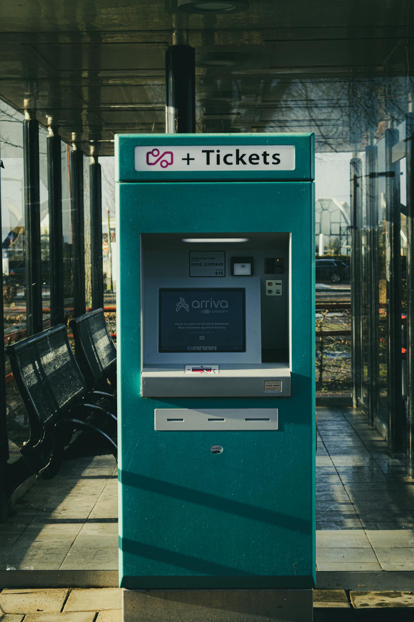 Ticket vending machine at Stavoren station in the Netherlands on a sunny day.